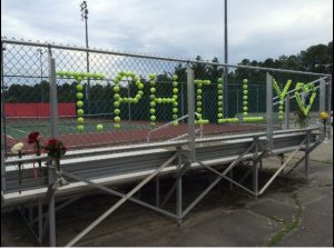 A memorial for Todd Phillips is created by the Godwin Tennis team in honor of their coach