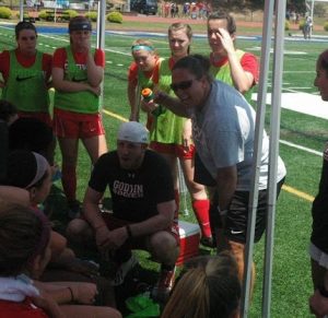 Girls soccer coach Ali Toole gives her team a pep talk during a time out
