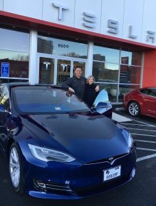 photo courtesy Rob White  White (l) with his wife and Tesla after buying the car. 